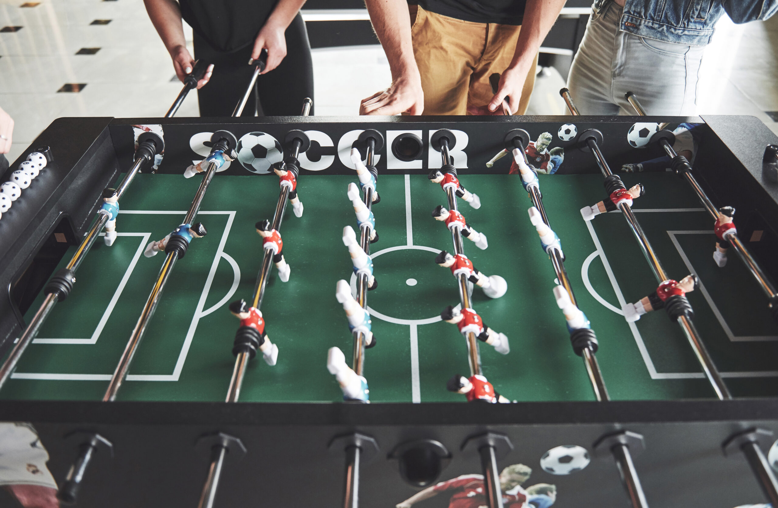 friends together play board games table football have fun free time scaled